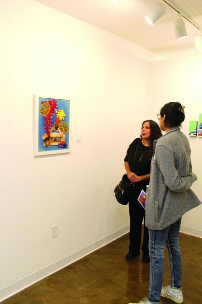 Artist Claudia Quintero Moseley talks with student Daniela Segovia about inspiration for her work.