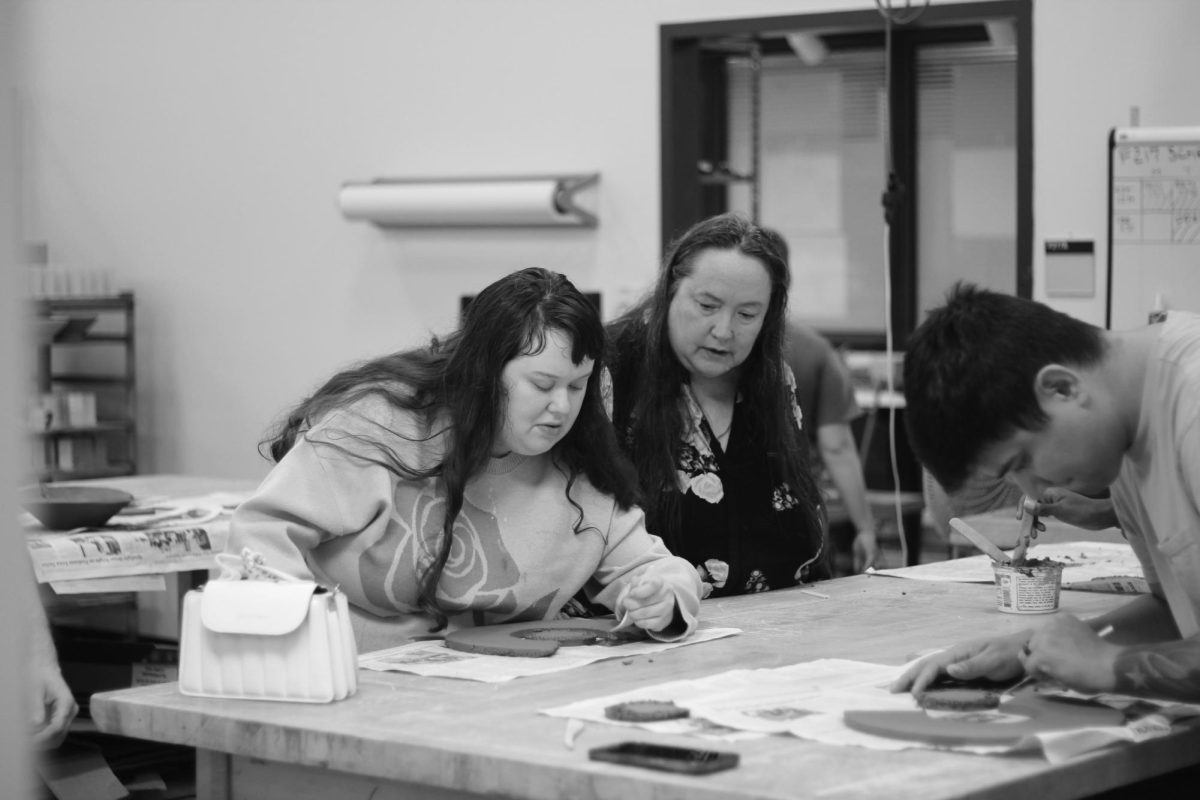 Mother/Daughter duo Karen and Lindsay participate in Bowls for Hunger event. Lindsay is seen here scoring her clay pieces.