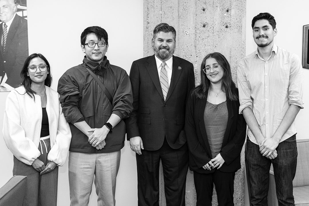 Chancellor Justin Lonon poses with student journalists during luncheon.