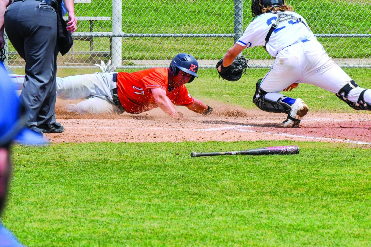 Michael Caputo, #27, slid into home base — solidifying yet another undisputed win of 11-0 — the cheers of fellow Harvester Bees rang out from the away team’s dugout at Northlake on Saturday April 26. 