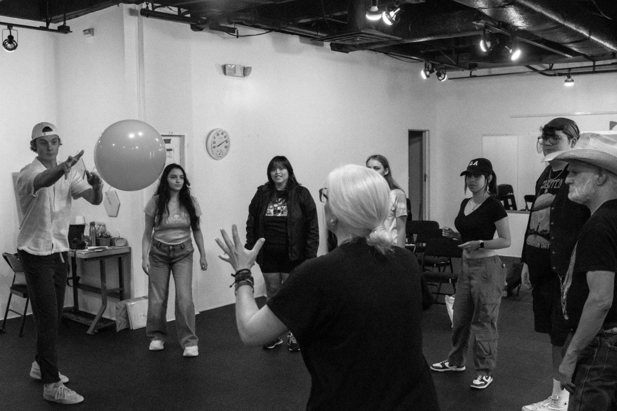 Theater students play an improv game that involves passing the ball back and forth to keep students on their feet while learning.